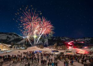 Fireworks explode with ski slopes in the background in Teton Village, WY.