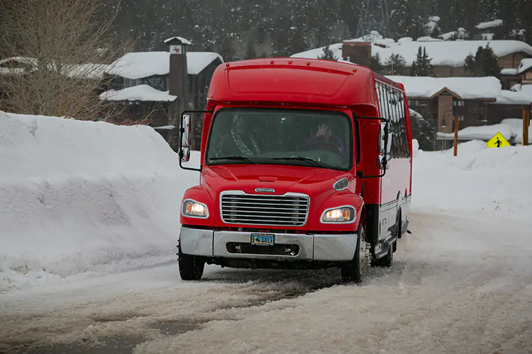 Jackson's Stilson Express Shuttle on snowy street in Teton Village, WY.